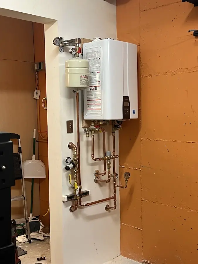 Plumbing technician inspecting water heater connections in Ocean City
